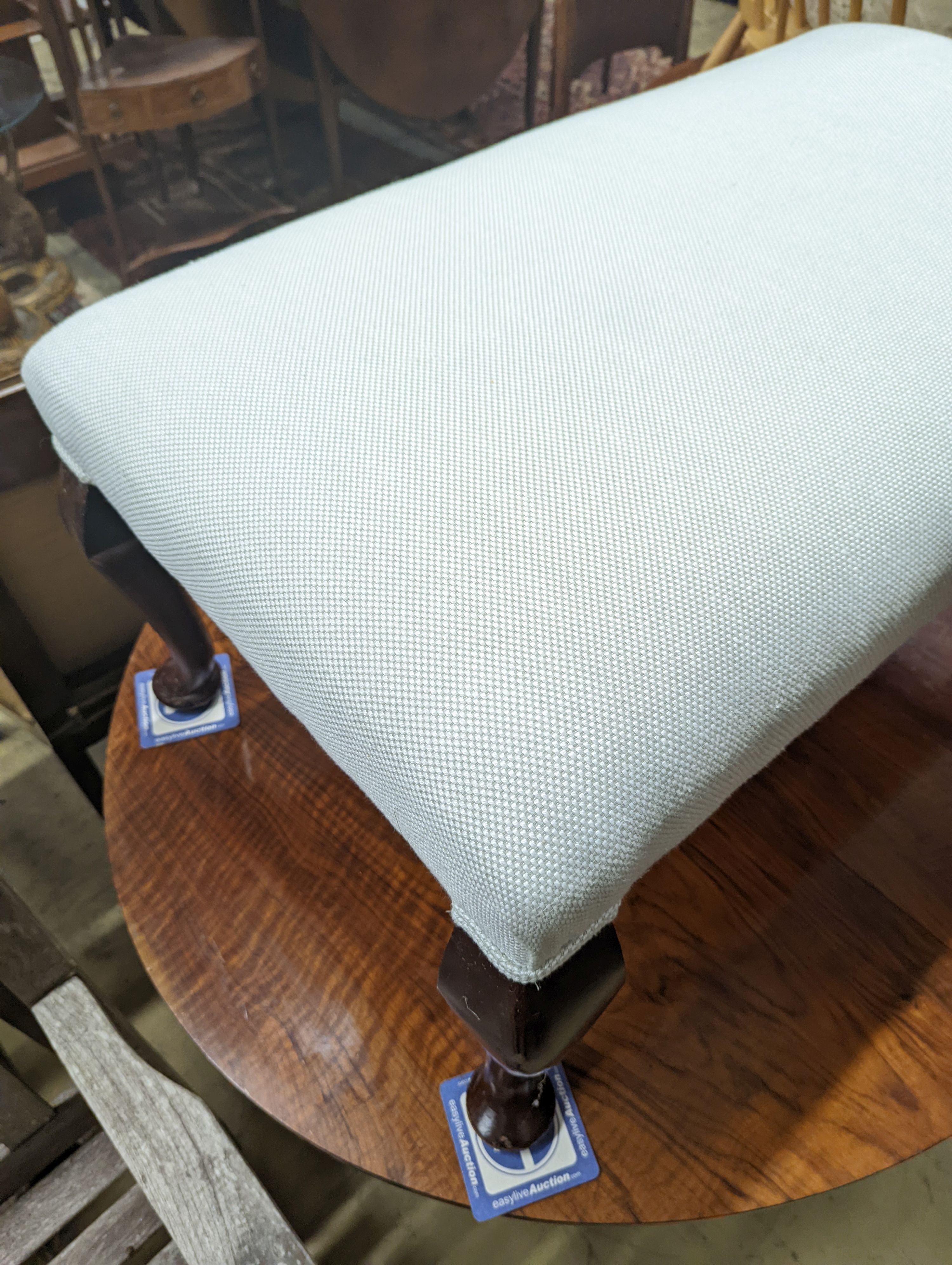 An early 20th century rectangular upholstered dressing stool, length 94cm, depth 54cm, height 42cm